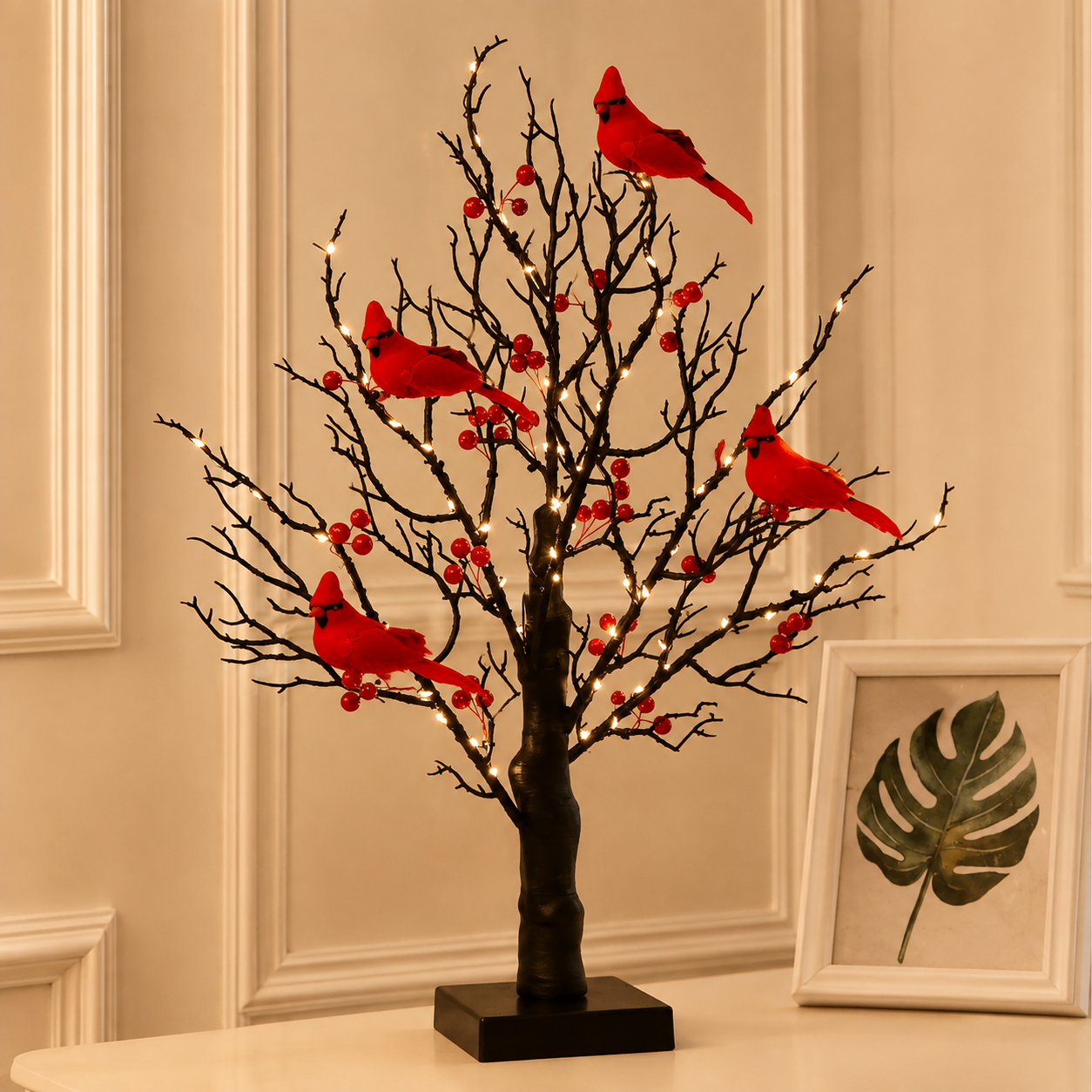 Four-bird cardinal tree with red berries and delicate bare branches against a warm interior wall