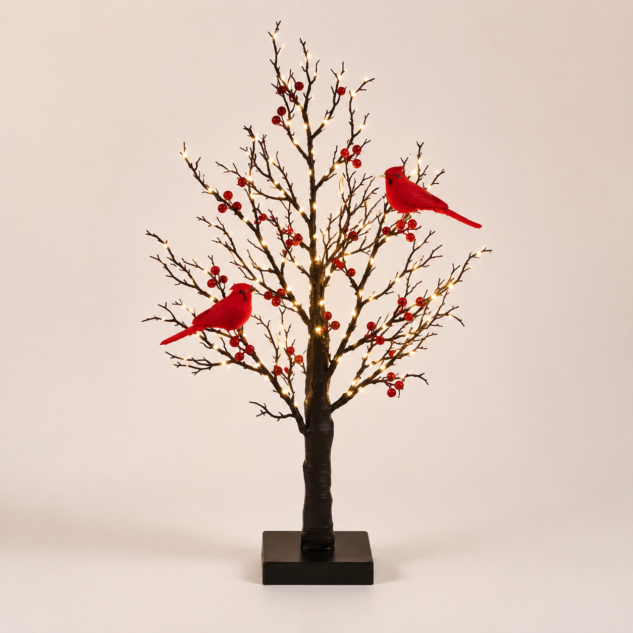Cardinal tree on a bright neutral background clearly showing two red birds, bare branches, berries and square black base