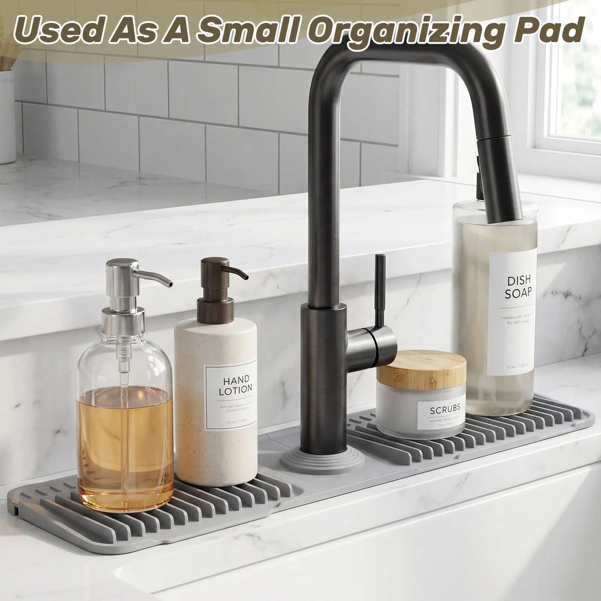 Gray silicone faucet mat used as an organizer for soap and bottles